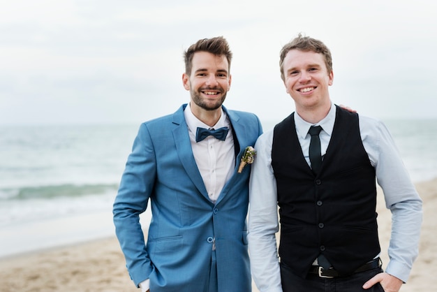 Groom and groomsman at the beach