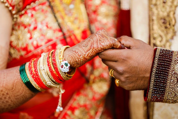 Groom holding bridal hand