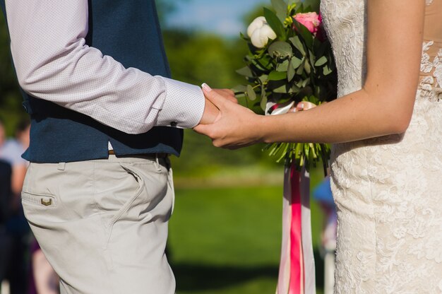 Groom holding hand of his bride