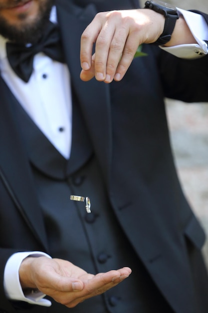 groom holding ring