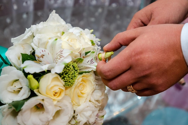 The groom holds a wedding bouquet Wedding day