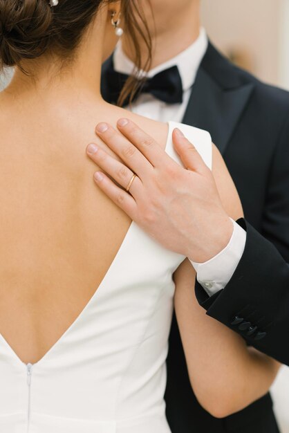 Groom hugs the bride by the shoulders Closeup of hands