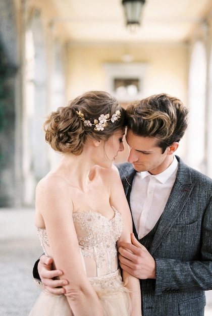 Groom hugs bride on the terrace Portrait