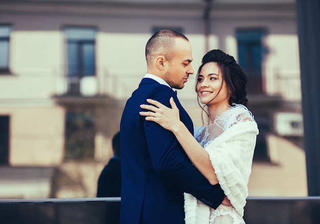 Groom hugs stunning bride