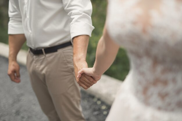 Groom keeps a bride hand and walking