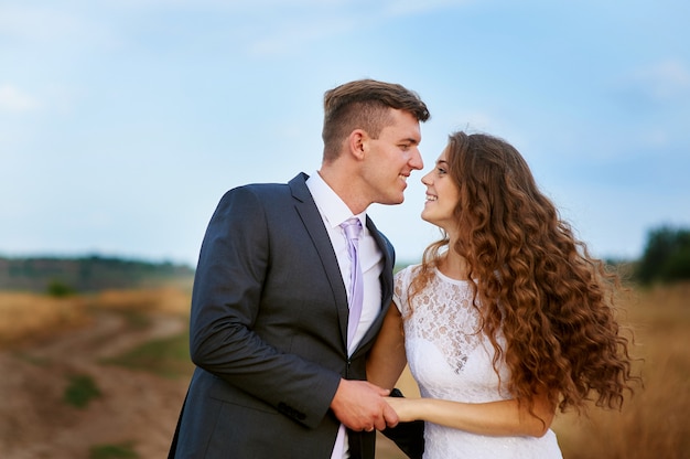 Groom kissing bride on their wedding day.