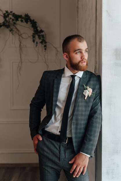 the groom looks at the bride from the window