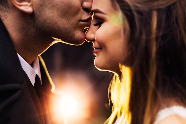 The groom in military uniform kisses the bride she closed her e