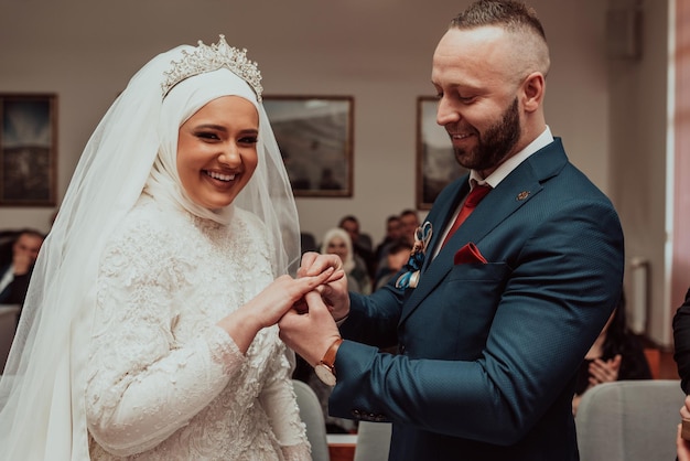 Groom Put on Wedding Ring Bride Hand Selective focus