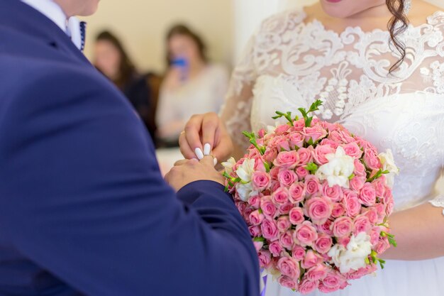 The groom puts the bride ring