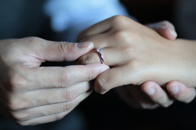 Groom puts the ring on the bride's hand in in Thai wedding ceremony traditional.