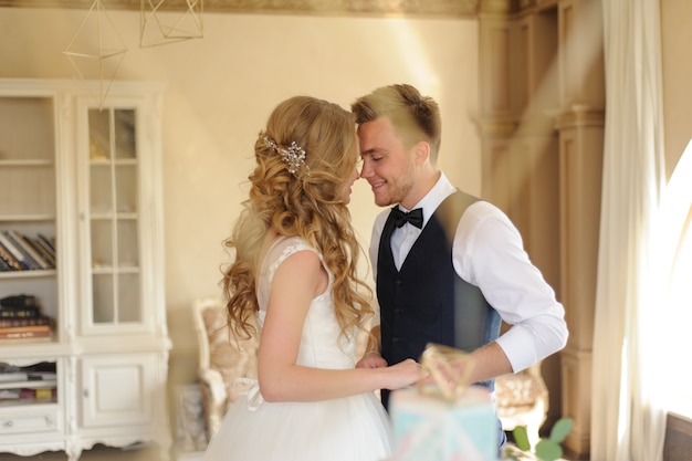 Groom puts a wedding ring on his bride.