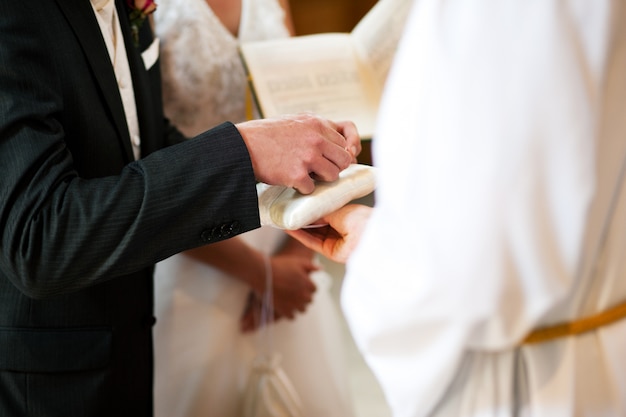 Groom taking rings in wedding ceremony