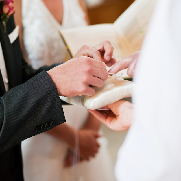 Groom taking rings in wedding ceremony