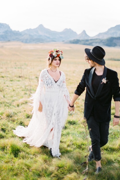 Groom turned his head to bride walking on the lawn