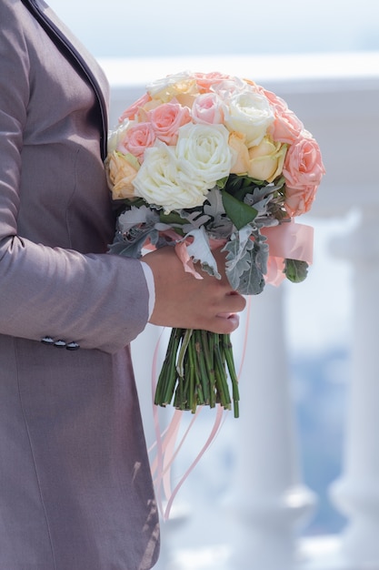 The groom was holding a bouquet of flowers to the wedding 