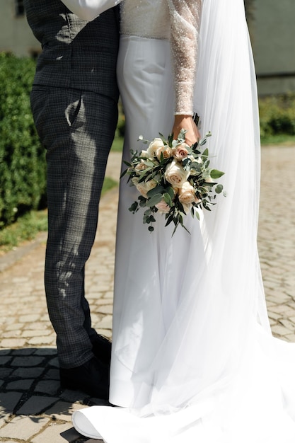 the groom with a beard in a vest walks with the bride wedding walk of the newlyweds