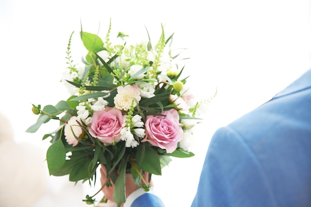 Groom with beautiful bouquet closeup