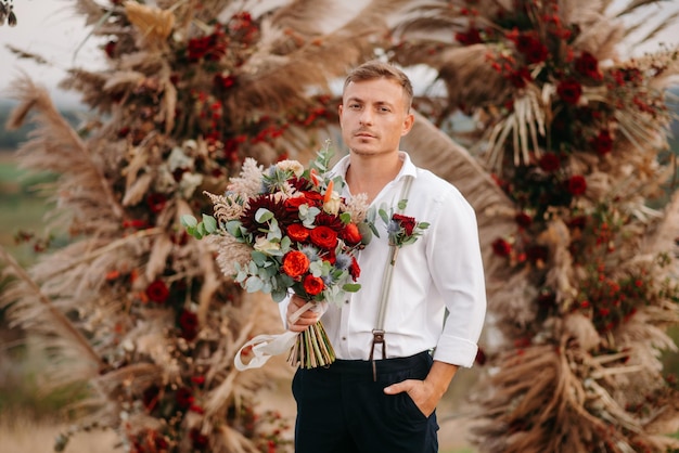 groom with bouquet of flowers