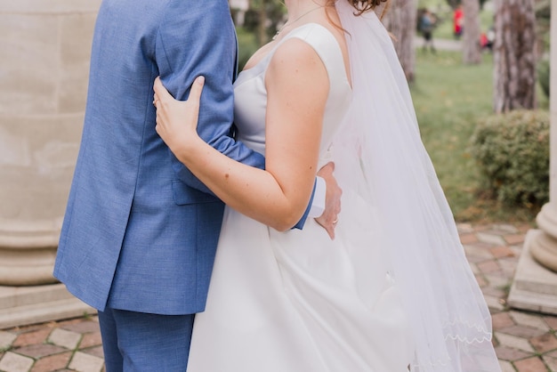 Groom with bride together autumn park at wedding