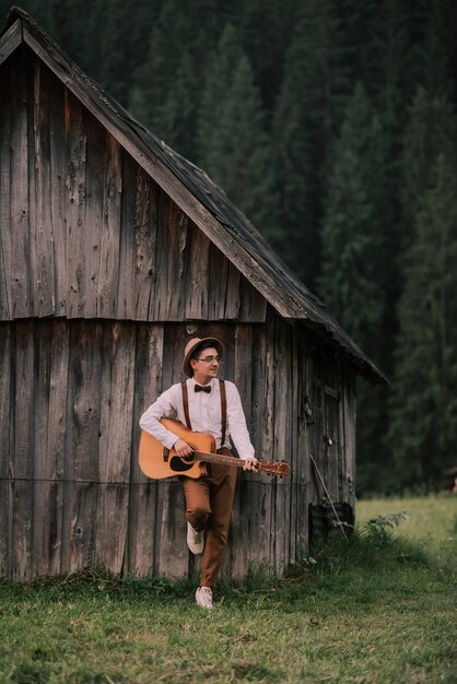 Groom with a guitar in a rustic style