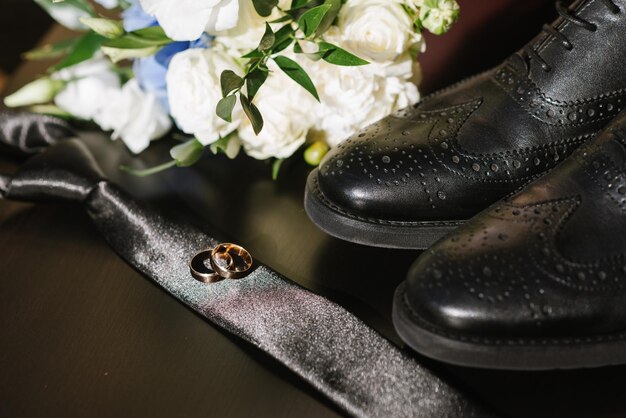 Grooms accessories for preparation on wedding day, shoes, rings and bouquet