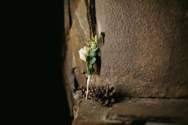 grooms boutonniere on stone background