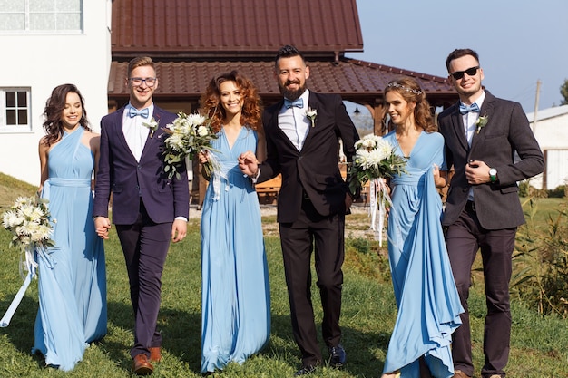 Groomsmen and bridesmaids walking on wedding ceremony