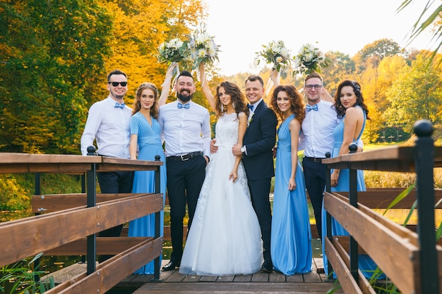 Groomsmen and bridesmaids with newly married on wedding ceremony