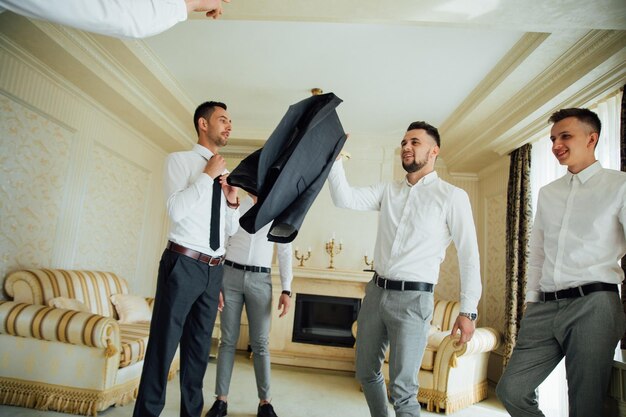 Groomsmen and groom posing on the wedding day.