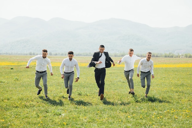 Groomsmen and groom posing on the wedding day.