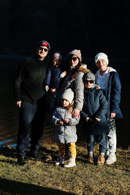 Groot gezin met vier kinderen in pond in early spring park