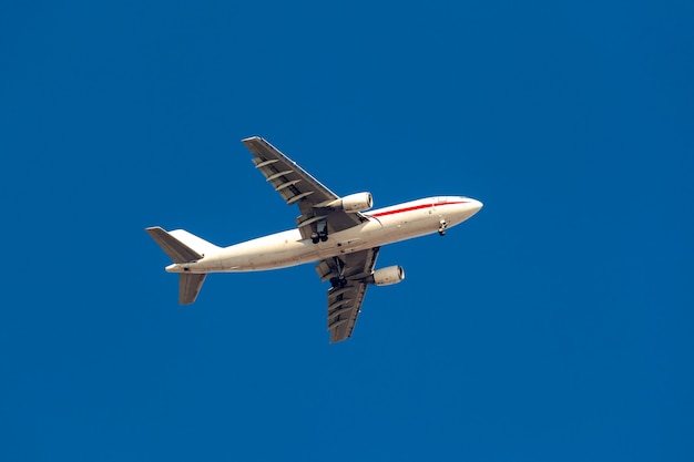 groot passagiersvliegtuig dat in de blauwe lucht vliegt