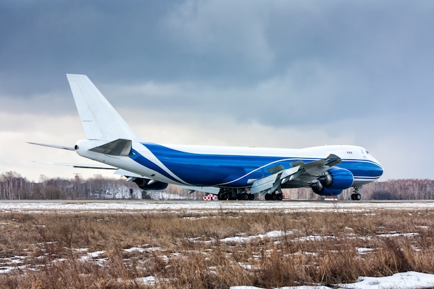 Groot vrachtvliegtuig beweegt op de startbaan op een koude winterluchthaven