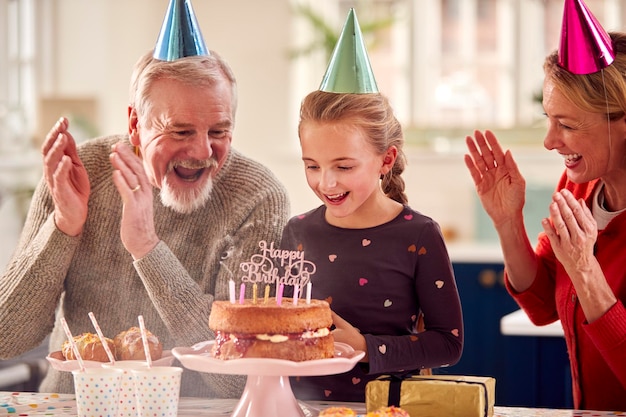 Grootouders met kleindochter vieren verjaardag met feestje thuis samen