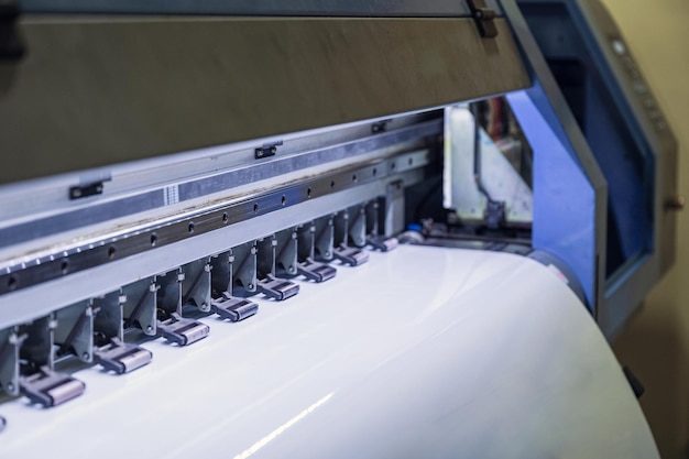 Foto grote inkjetprinter printen op vinylpapier in werkplaats
