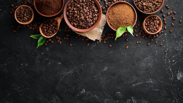 Ground coffee and coffee beans Assortment of coffee varieties on a black background Top view Free space for your text