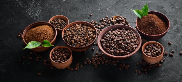 Ground coffee and coffee beans Assortment of coffee varieties on a black background Top view Free space for your text