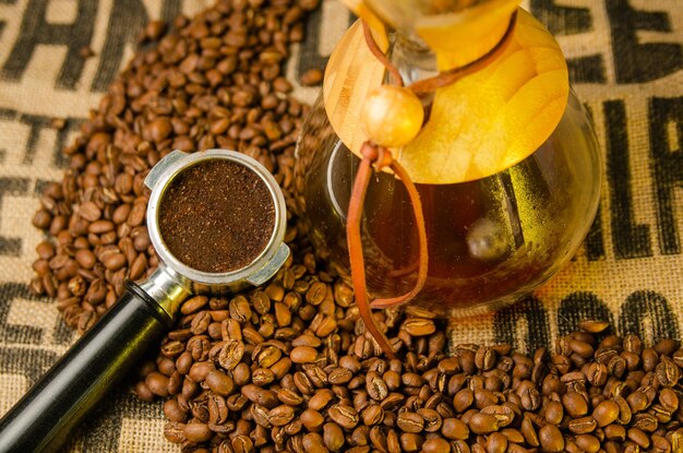 Ground coffee on coffee beans on a table with natural background