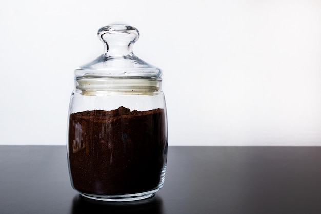 Ground coffee in a glass jar on the table