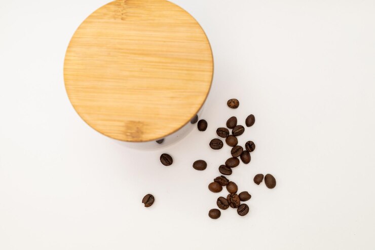 Ground coffee in a jar on a white background