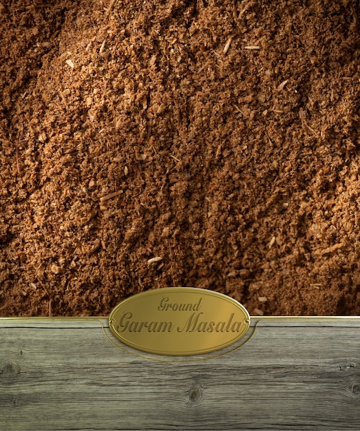 Ground Garam masala spices frame in wood with a golden label