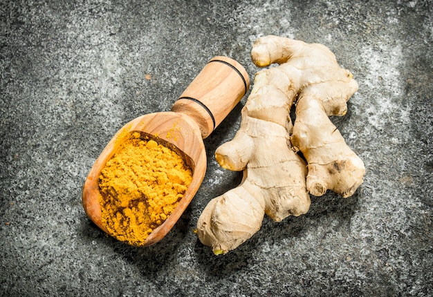 Ground ginger in a wooden scoop.