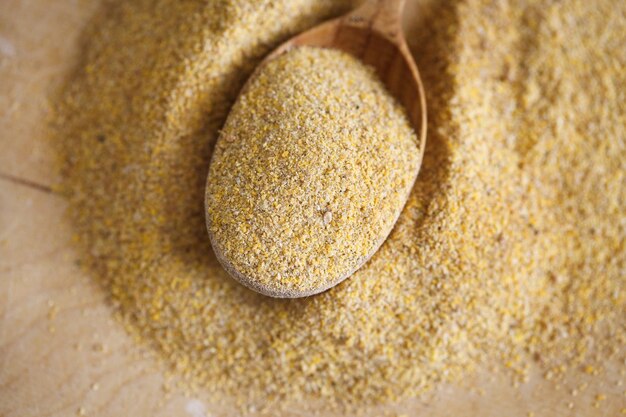 Ground mustard in a wooden spoon on the table