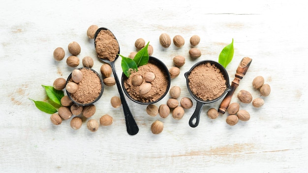 Ground nutmeg in bowls on a white background Indian spices