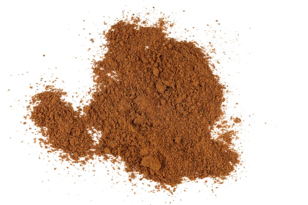 Ground nutmeg seasoning heap white background