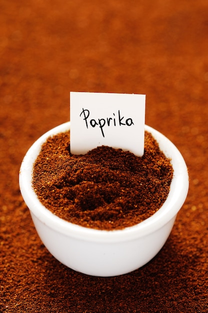 Ground paprika in a white ceramic bowl