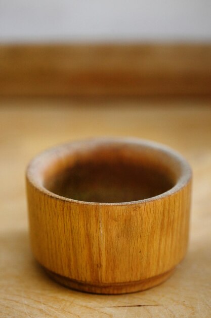 Ground walnuts and walnut kernel halves in wooden bowl