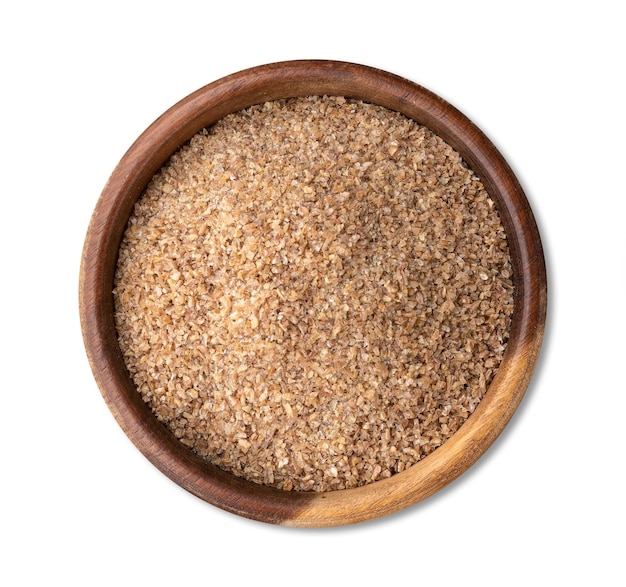 Ground whole wheat in a bowl isolated over white background