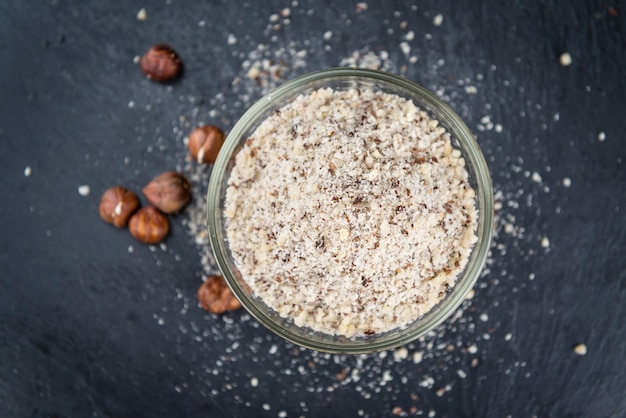 Grounded hazelnuts on a slate slab